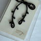 Black ribbon brooch in nobling branded packaging