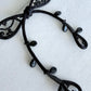 Black ribbon brooch by certified artisan Saito, flat lay detail view